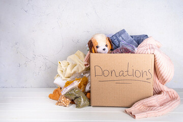 Donation box with clothes, toys and food - obrazy, fototapety, plakaty