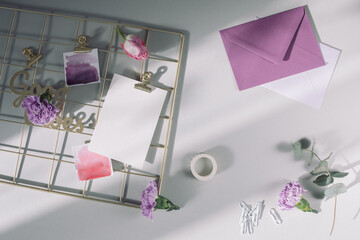 Office desk table with blank paper card, envelope, keyboard. Inspiring mood board and stationery...