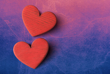 Close up of two valentines hearts on pink blue stone background with copy space. Valentines day greeting card template