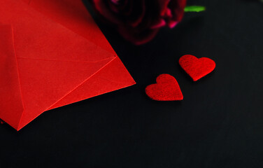 Red envelopes and heart symbols on black background