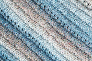 Knitted background. Knitted fabric texture, pure sheep wool, color gradient.