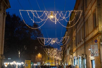 historic center of modena lit up at christmas with shop windows and shops decorated for christmas...