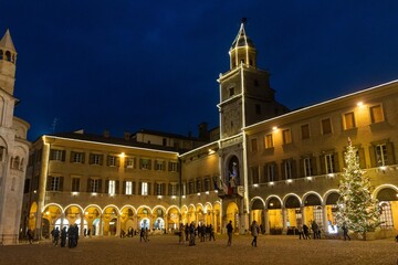 historic center of modena lit up at christmas with shop windows and shops decorated for christmas...