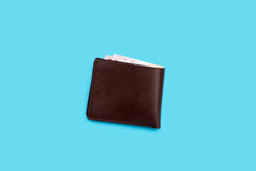 Brown wallet on blue background