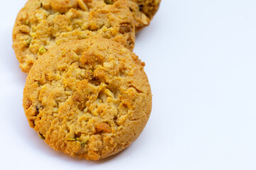 Pistachio and almond cookies on white background.