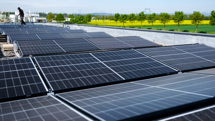 Male team engineers installing stand-alone solar photovoltaic panel system. Electricians mounting...