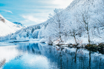 Picturesque landscape of a snowy winter mountain lake. Small lake next to the Saut Deth Pish...