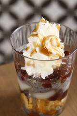 Black sesame ice cream with mochi, red beans, whipped cream and caramel sauce dessert