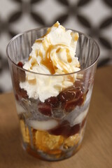 Black sesame ice cream with mochi, red beans, whipped cream and caramel sauce dessert