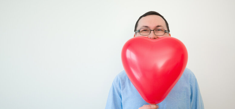 Valentines day banner with place for text. Man hiding behind heart balloon