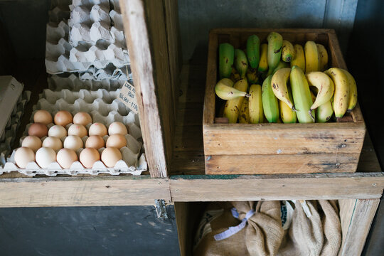 Eggs and Bananas in rustic store shelves