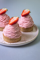Strawberry Mont Blanc dessert with whipped cream and fresh strawberry on a silver table