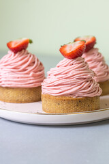 Strawberry Mont Blanc dessert with whipped cream and fresh strawberry on a silver table