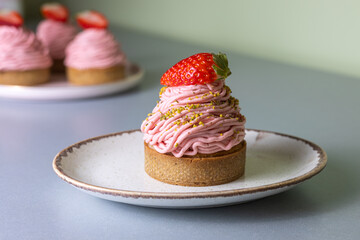Strawberry Mont Blanc dessert with whipped cream and fresh strawberry on a silver table