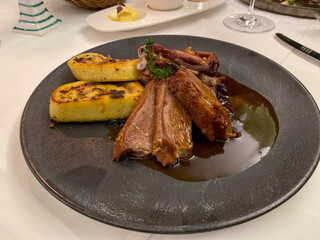 Main course, roasted breast of goose with roasted potatoes on a finely decorated table, Hesse, Germany
