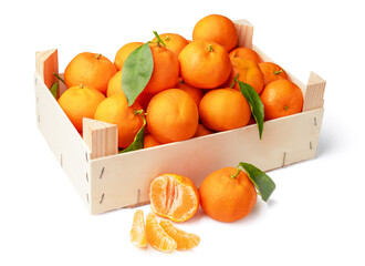 Orange tangerines with green leaves in a box. Tangerine is divided in half and into pieces. isolated on white background