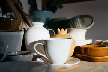still life with ceramic cups on wooden surface