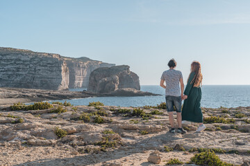 Couple enjoying the beautiful views of the cliffs in Gozo. 