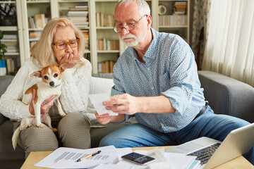 Senior couple worried looking at the costs and expenses