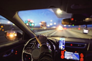 Driving a car at night in the city with navigation - 559745668
