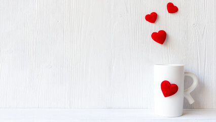 Valentine Day with white cup coffee red heart on the cup, wood white background. Valentine Concept. Copy space for banner