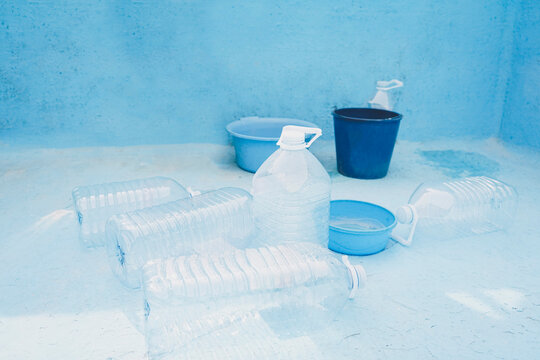 Plastic bottles and bucket in empty pool