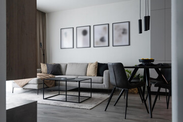 Living-room with sofa and dining table in modern apartment