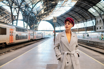 Stylish woman posing in a train station