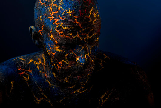 Conceptual Portrait of a brutal man painted in face art style over bla