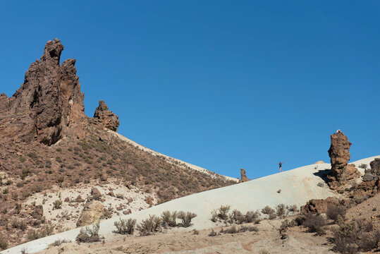 Scenery with hills, rock formation and trail runner, Piedra Parada area, Chubut Province, Patagonia, Argentina