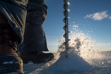 A drill is used to drill holes through the frozen ocean to measure thickness of the ice in McMurdo Sound, Ross Sea, Antarctica.