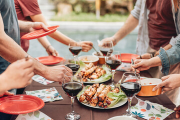 people celebrating at party with wine and skewer