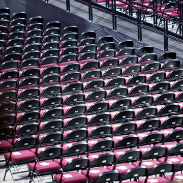 High angle view of rows of empty folding chairs in indoor auditorium.