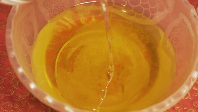 Pouring Lye solution into natural organic oil saponification soap making