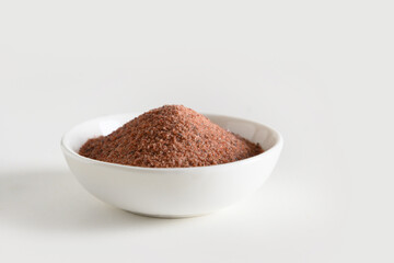 Indian Black salt Kala namak in white bowl. Useful for vegetarians as a source of iron. Close up....