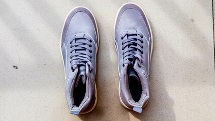 the gray sneakers on the floor