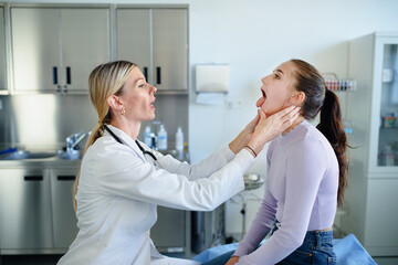 Young woman doctor examining teenage girl in her ambulance.