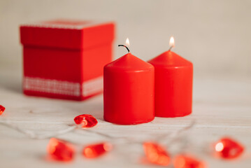 Beautiful composition with red candles on the white wooden table. Romantic love image