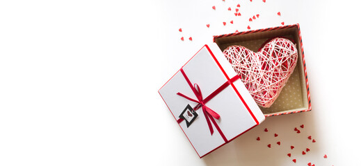valentine's day. open gift box with big heart on white background with copy space. concept of giving love