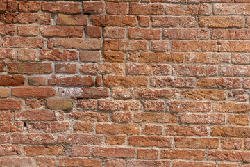 Old red brick clay wall with on a sunny day. Clay brick walls of Italy. italian architecture and heritage