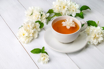 Jasmine tea in a cup on a wooden background. Copy space
