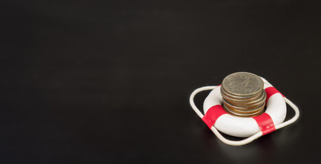 Stack coin in lifebuoy.
Concept security of money, guaranteed deposits. Client rights protection....