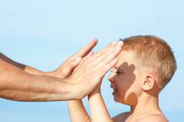 beautiful hands of parent and child by the sea