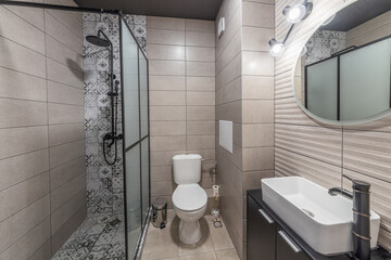 Clean bright stylish designer modern bathroom. Bathroom interior in luxury home with glass shower