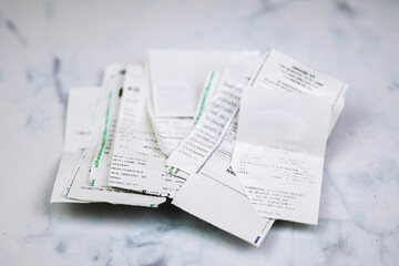 Pile of shopping receipts and credit card slips on white background. Debt and household...