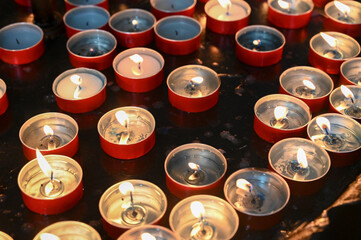 Burning candles my alter in church altar. Prayer candles in Catholic church.