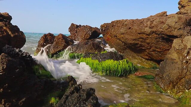 Waves hitting the rocks on the La Pineda beach in Salou Spain.