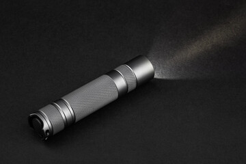 Modern aluminum LED Pocket Flashlight isolated on white background. 