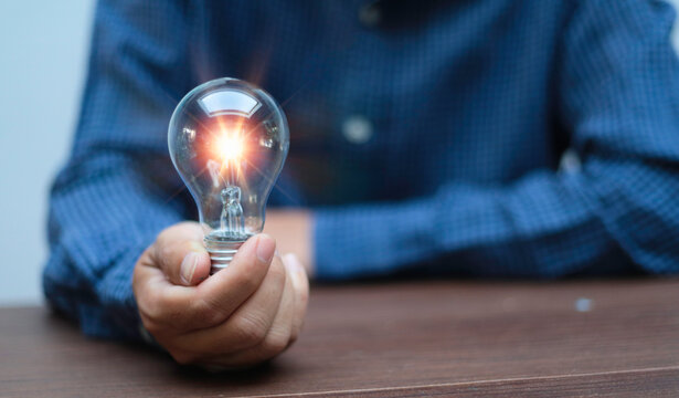 Businessman and a bright light bulb. Concept of Ideas for presenting new ideas Great inspiration and innovation new beginning