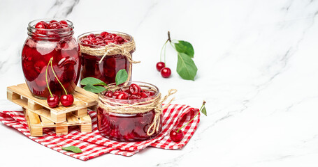 Berries cherry with syrup. Berries cherry with syrup. Canned fruit on a light background. Long banner format